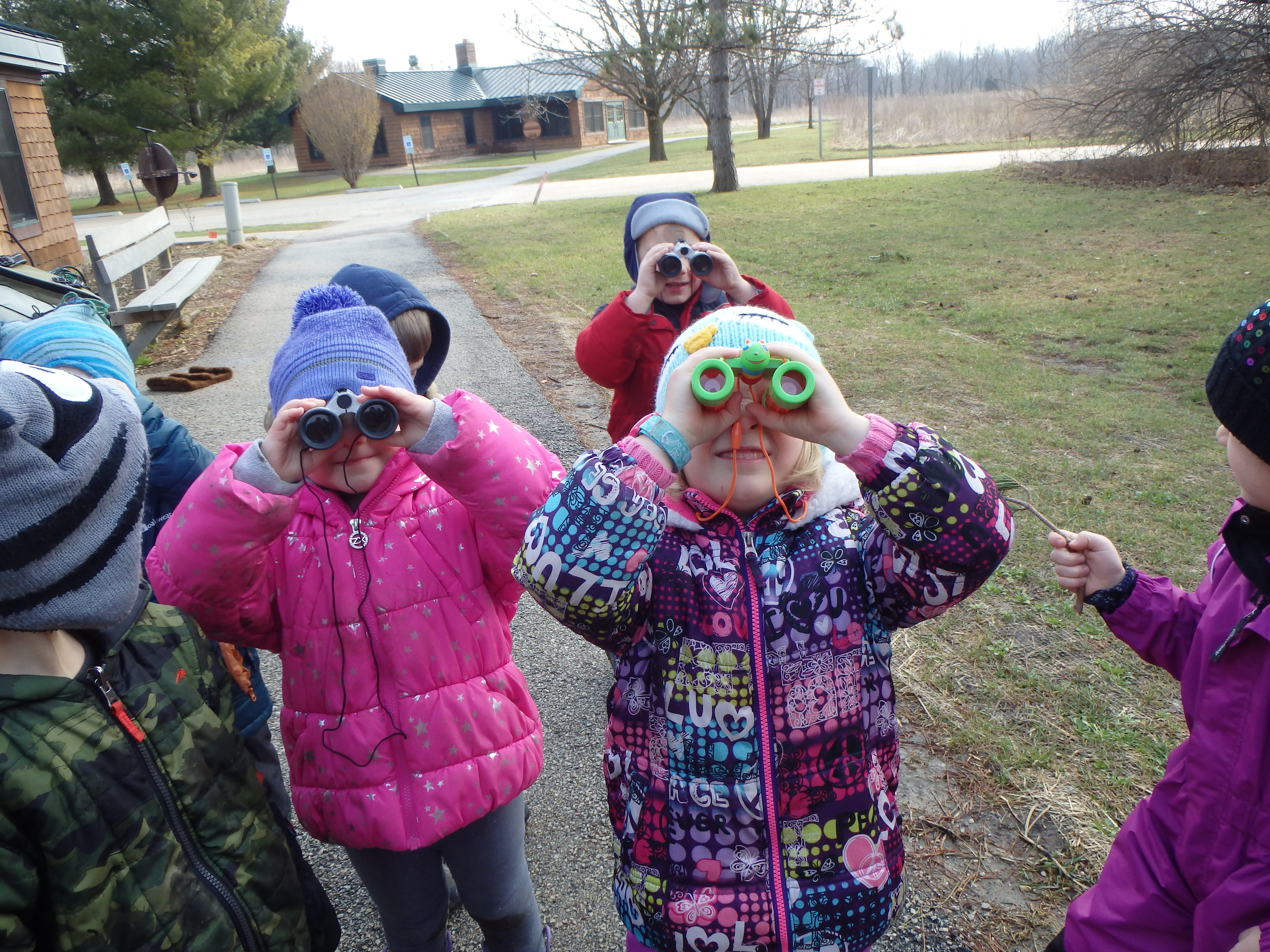 young children using binoculars to bird watch